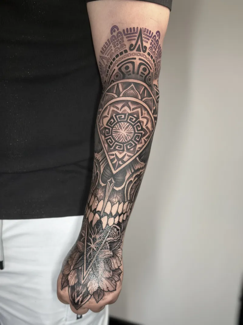 Blackwork mandala sleeve running down to the hand