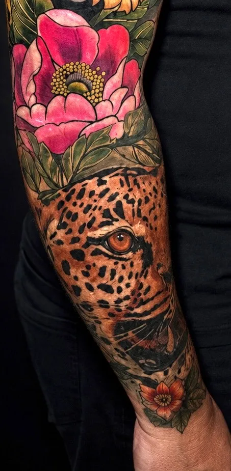 Full colour sleeve tattoo with a peony, leopard print and a hidden eye, by Omaha tattoo artist Nataly Fierro