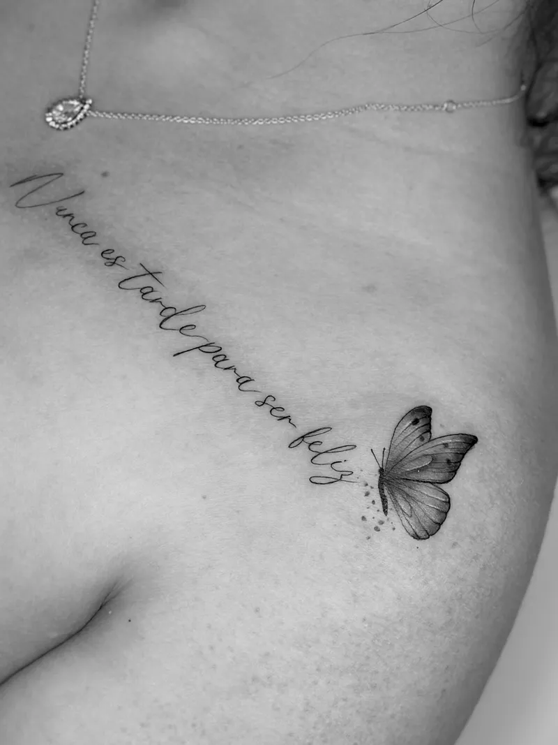 Fine line script with a small butterfly across the shoulder blade