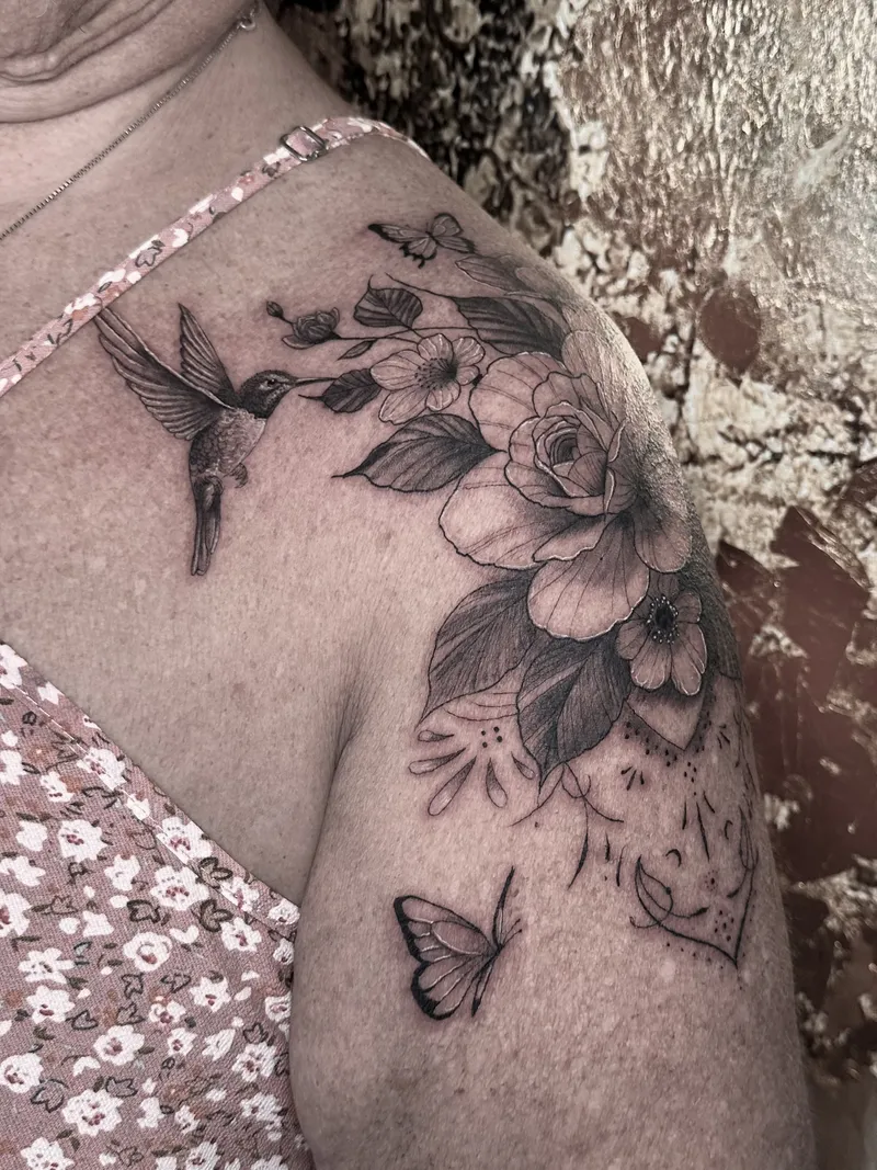 Fine line hummingbird, roses and a butterfly on the shoulder
