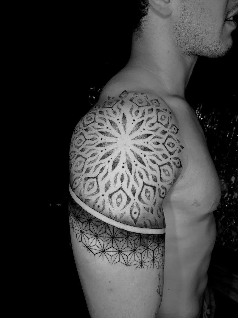 Geometric dotwork mandala across the shoulder and chest