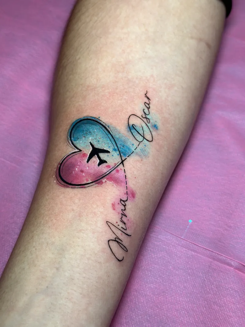 Watercolour heart in pink and blue with an airplane and script